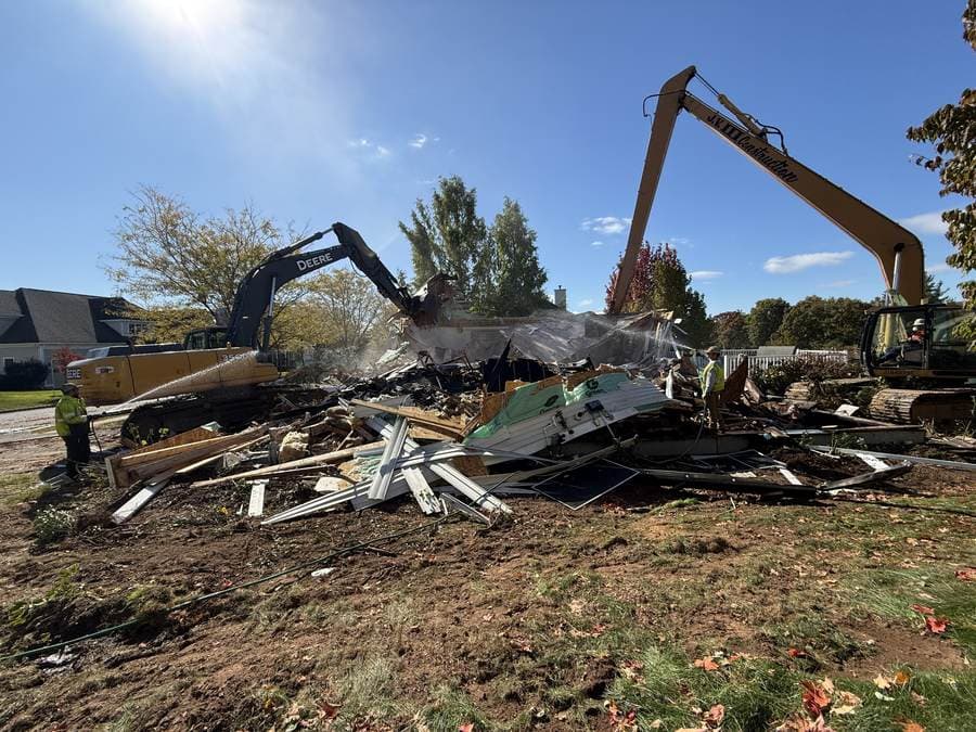 Two W&K excavators with dust suppression during a large-loss demolition