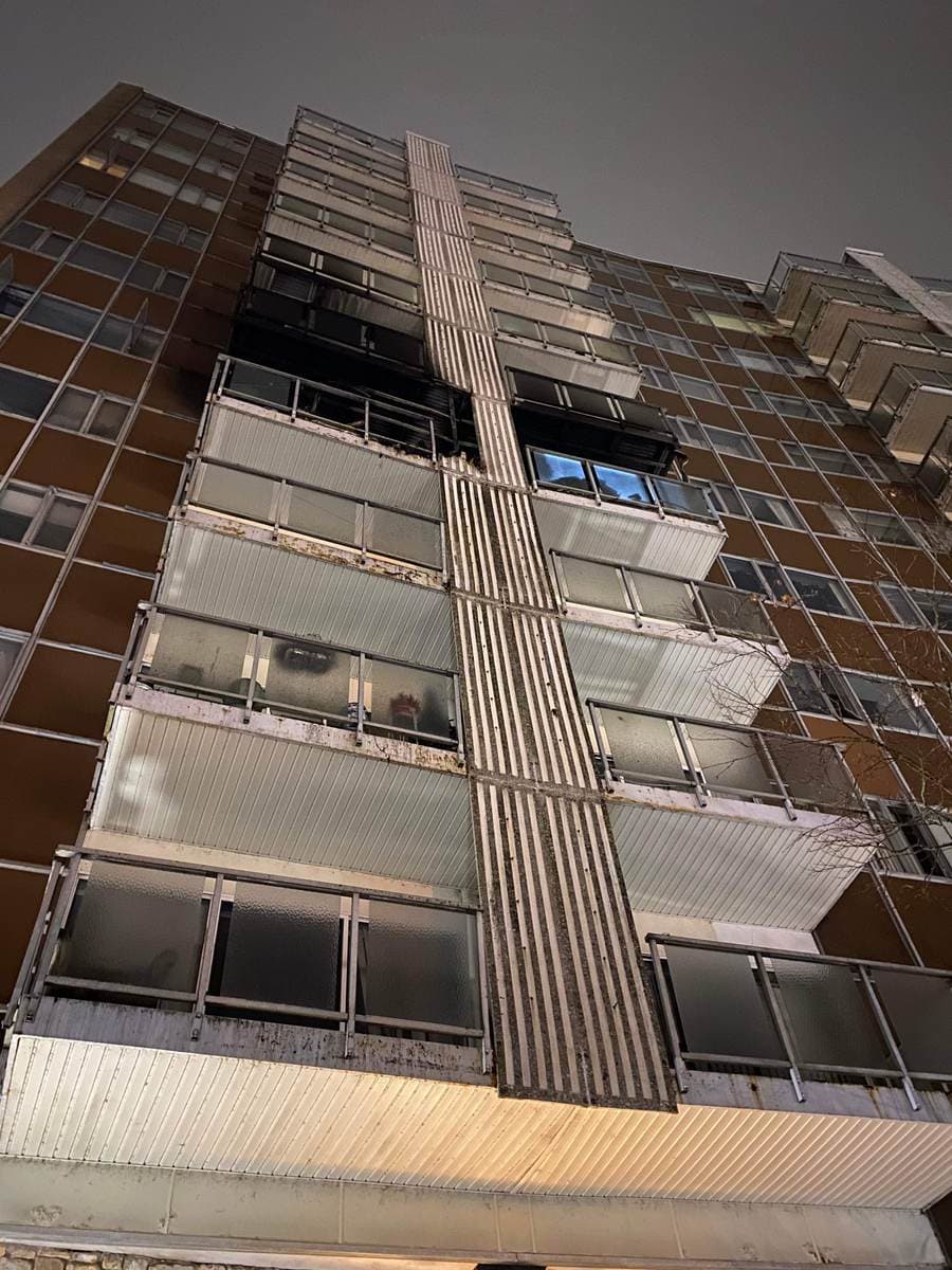 High-rise residential building with upper-floor fire damage, a multi-family loss