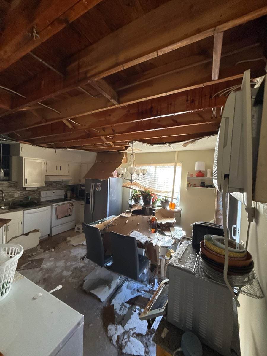 Collapsed ceiling over a kitchen and dining area after a water loss